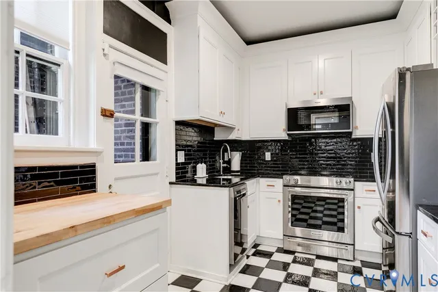 a view of a hallway with wooden floor a bedroom and a bed