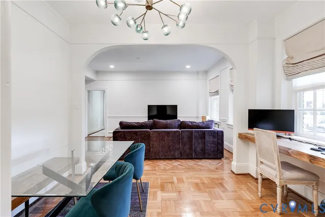 a bedroom with furniture and a large window