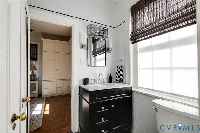 a bathroom with a sink a toilet and a mirror