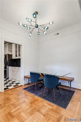 a kitchen with white cabinets and appliances