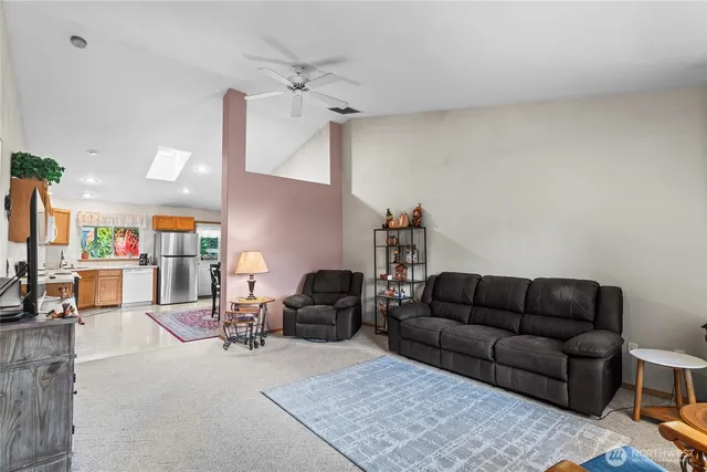 a living room with furniture a rug and white walls