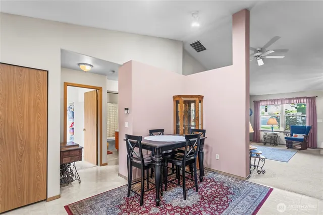 a view of a a dining room with furniture window and wooden floor