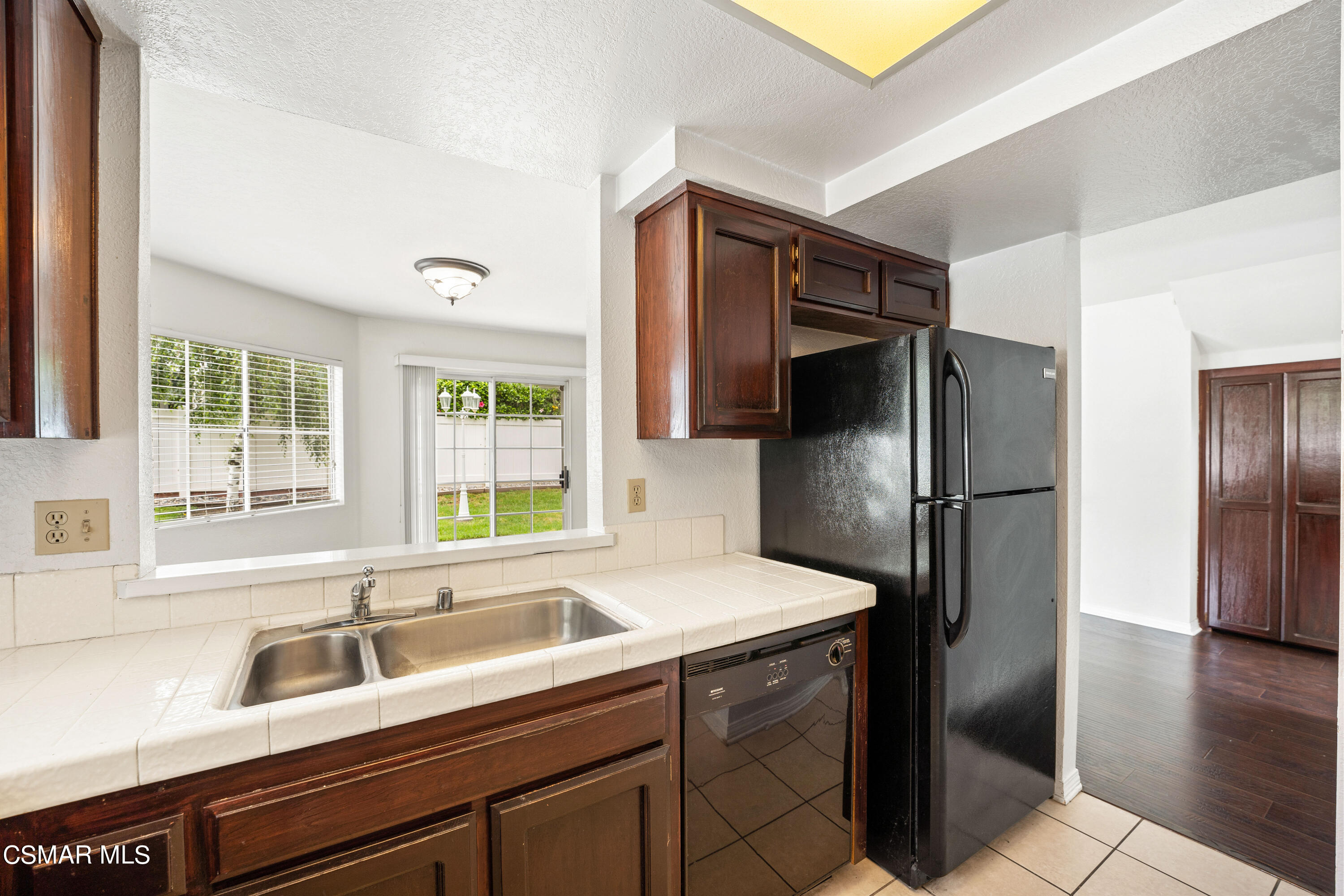 1866 Rory Lane, Unit 6 Simi Valley, CA 93063 - Photo 11 of 25 a kitchen with a sink and a refrigerator