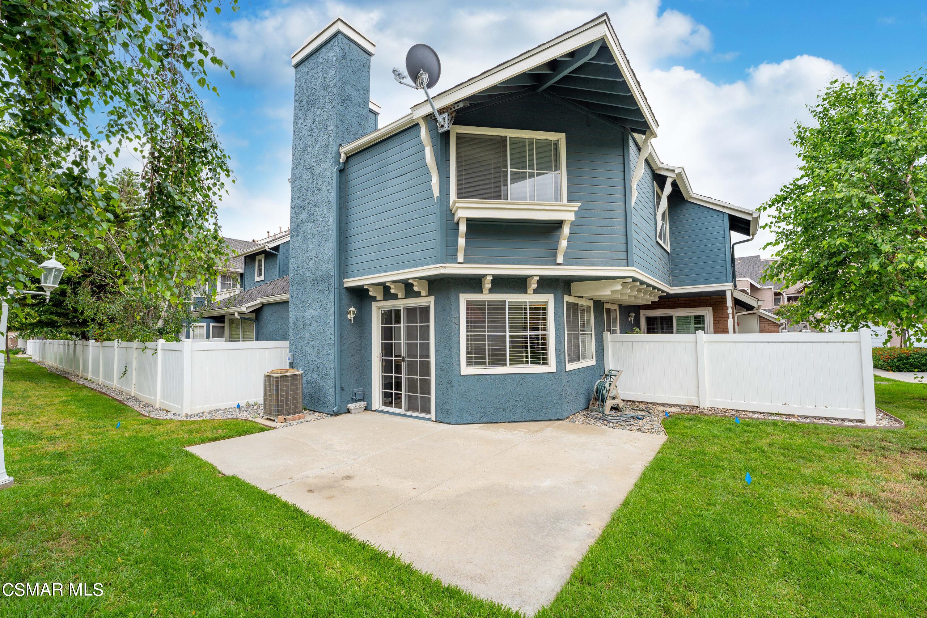 1866 Rory Lane, Unit 6 Simi Valley, CA 93063 - Photo 22 of 25 a front view of a house with a yard and trees