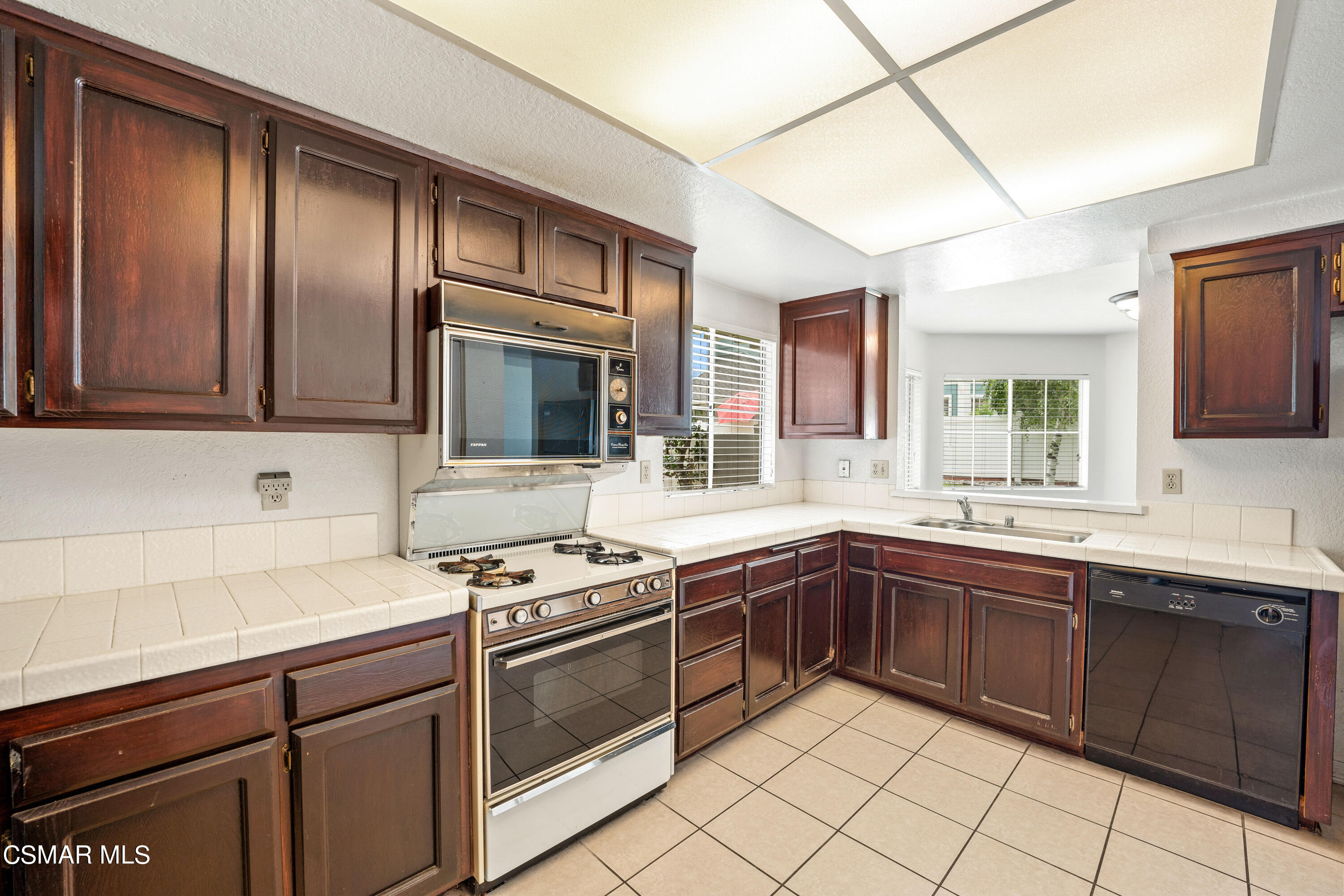 1866 Rory Lane, Unit 6 Simi Valley, CA 93063 - Photo 9 of 25 a kitchen with stainless steel appliances granite countertop stove top oven sink and cabinets