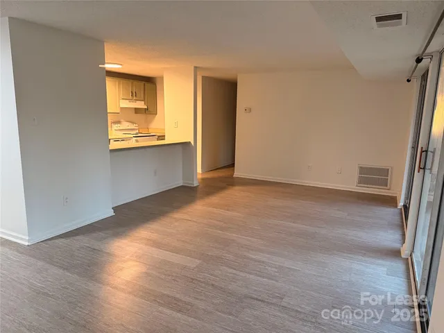 an empty room with wooden floor and a window