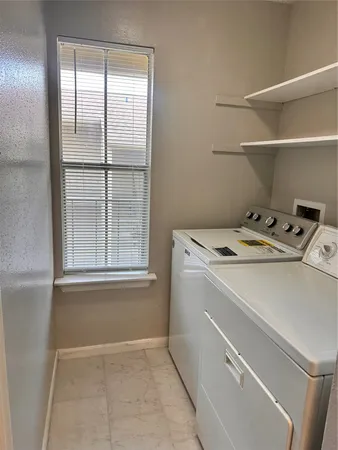 a utility room with washer and dryer