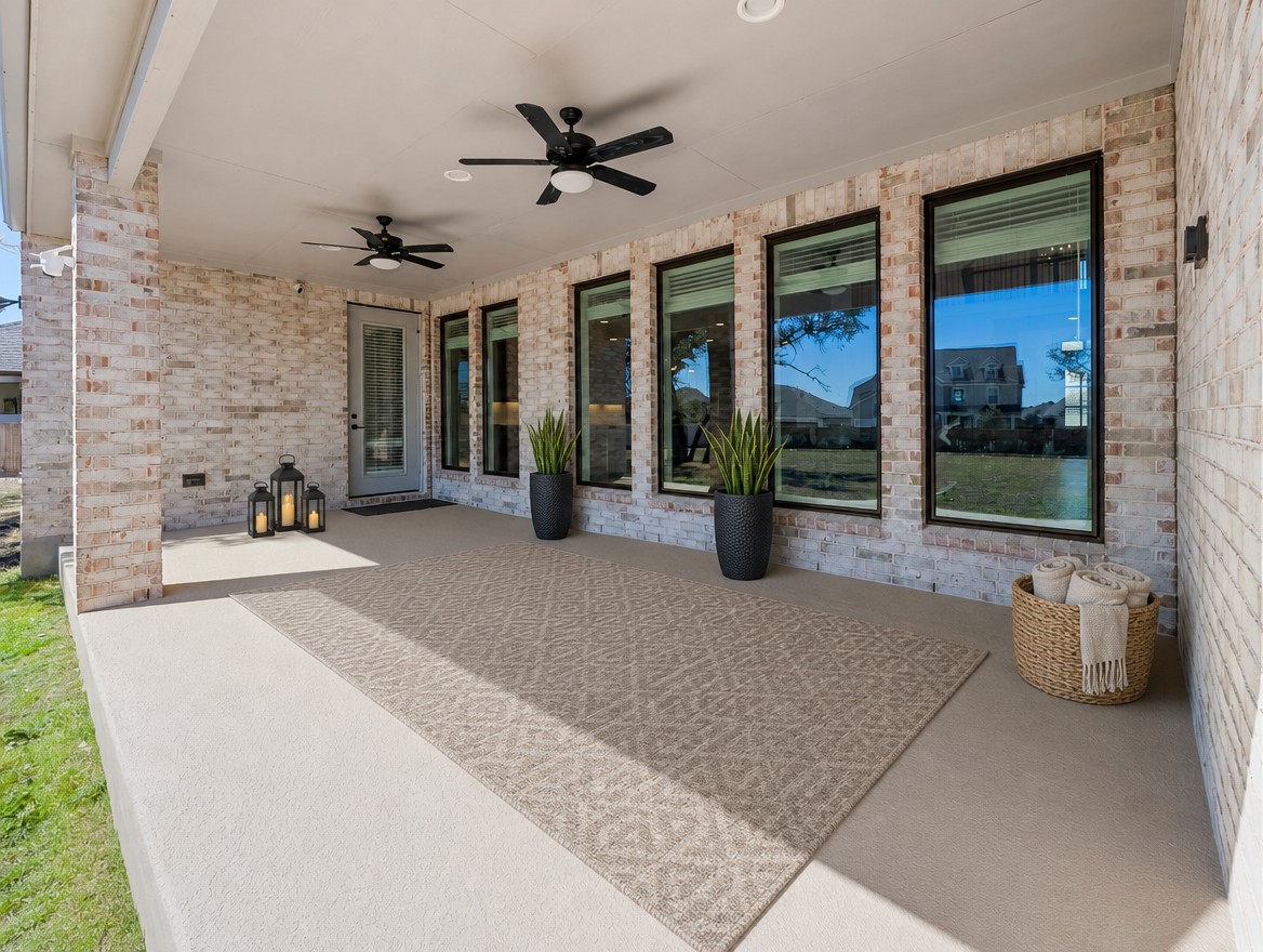 1440 Riva Ridge Drive Leander, TX 78641 - Photo 28 of 37 An inviting covered patio features ceiling fans and brick walls, perfect for outdoor relaxation.