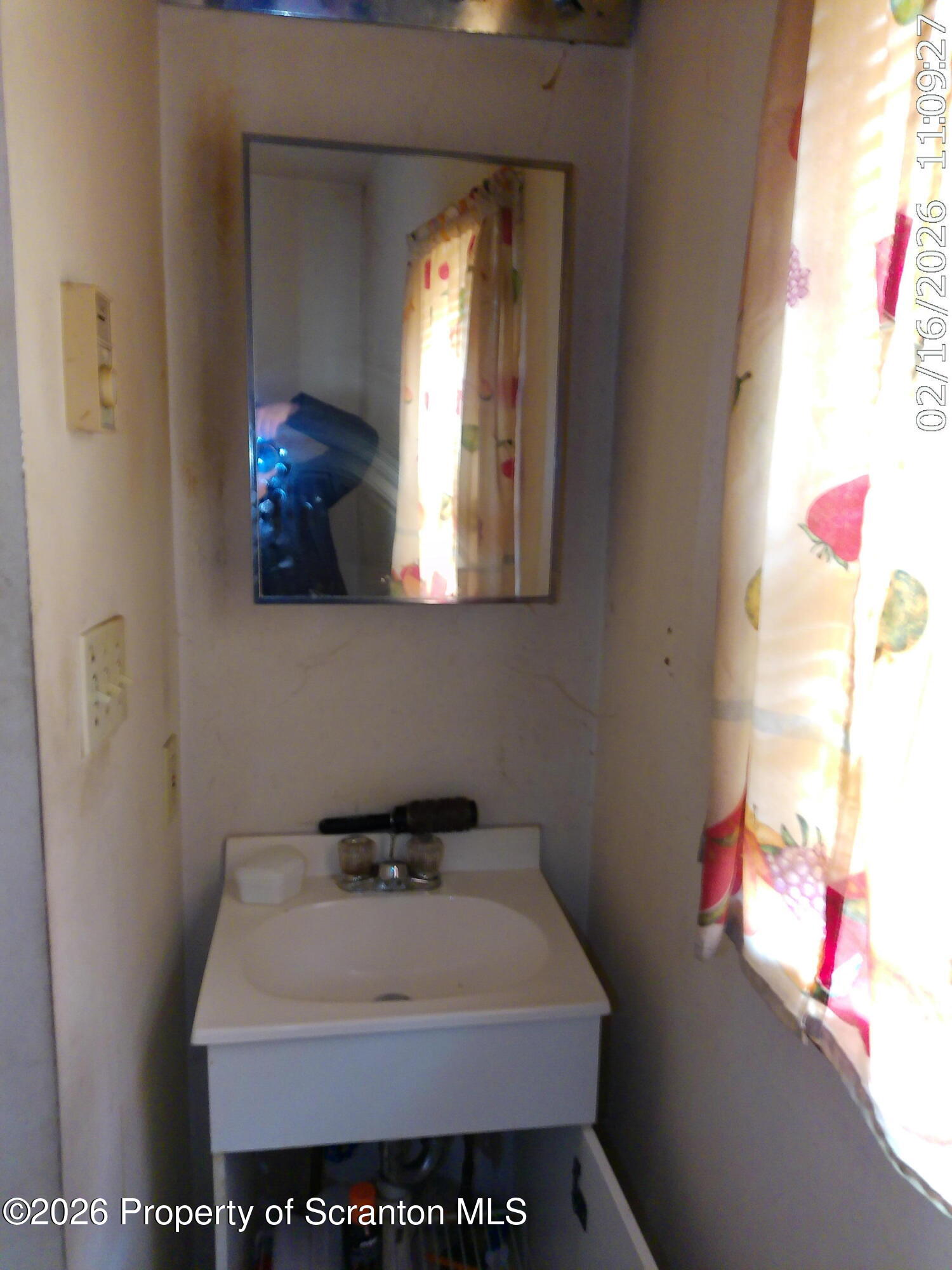 319 South 9th Avenue Scranton, PA 18504 - Photo 12 of 49 a bathroom with a sink and a mirror