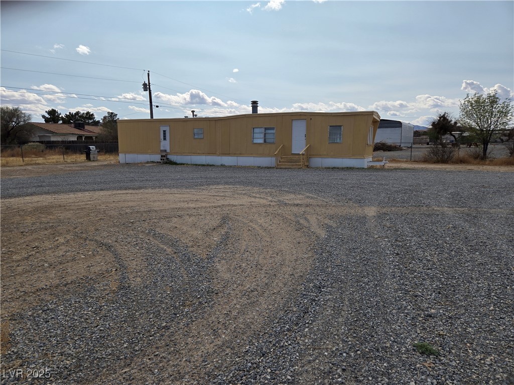 3331 West Simkins Road Pahrump, NV 89060 - Photo 4 of 6 Manufactured / mobile home with entry steps and fence