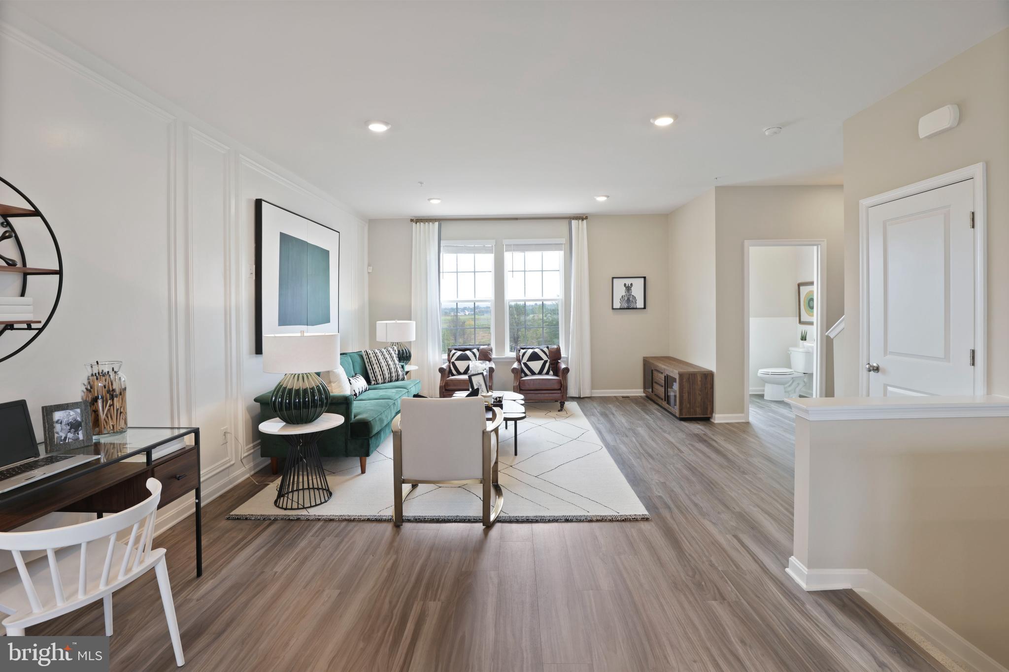 1271 Apollo Drive Frederick, MD 21702 - Photo 33 of 35 a living room with furniture a large window and wooden floor