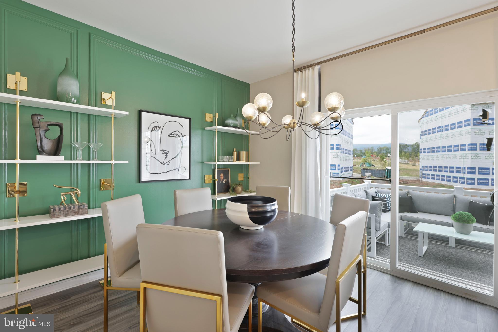 1271 Apollo Drive Frederick, MD 21702 - Photo 10 of 35 a dining room with furniture a potted plant and a chandelier