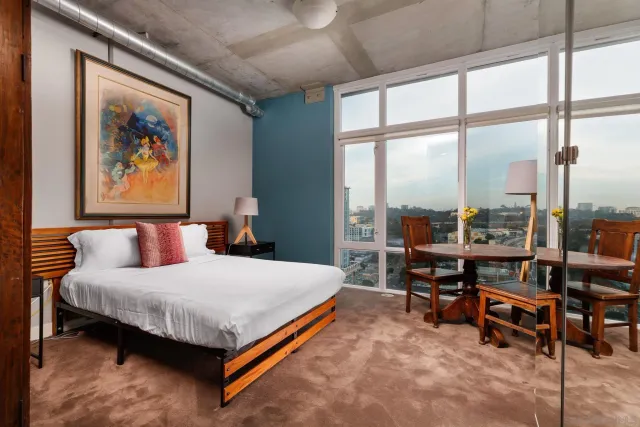 a bedroom with a bed and a large window