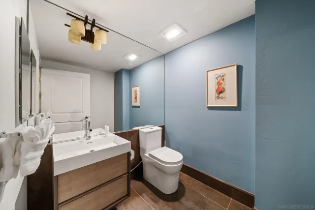 a bathroom with a bathtub sink mirror and toilet