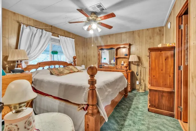 a view of a hallway with chandelier and a mirror