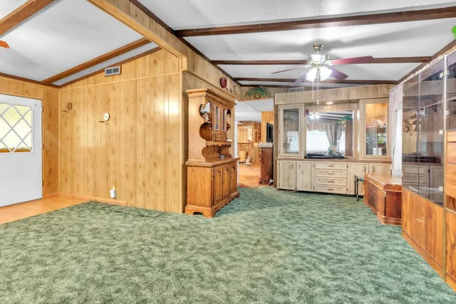 a living room with stainless steel appliances kitchen island granite countertop furniture and a kitchen view