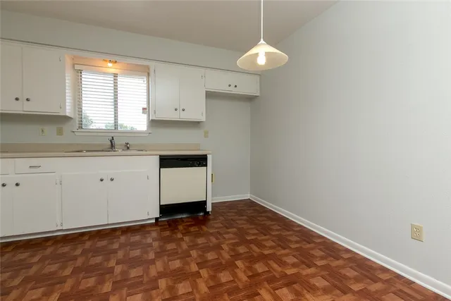 a kitchen with a sink cabinets and a window