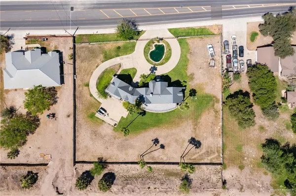 an aerial view of a wooden chairs with potted plants