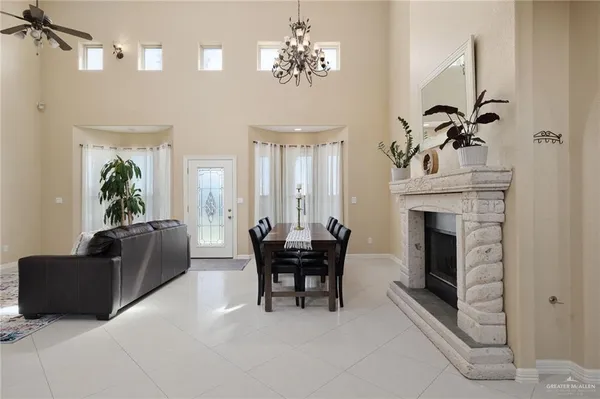 a living room with furniture a chandelier and a fireplace