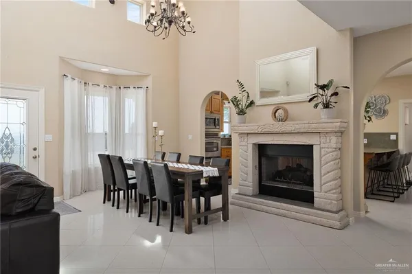 a living room with furniture a fireplace and a dining table