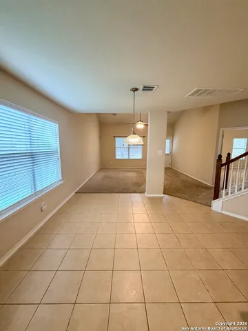 a view of a livingroom with an empty space and a window