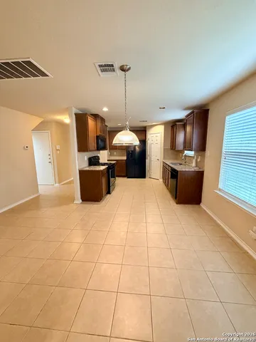 an empty room with a ceiling fan and window