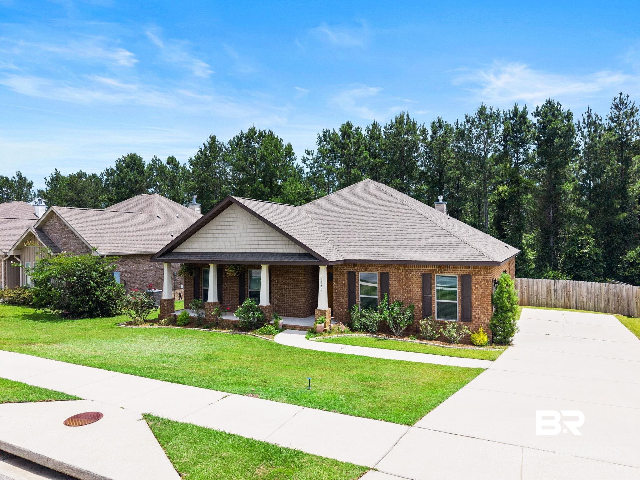 31350 Hoot Owl Road Daphne, AL 36527 - Photo 52 of 94 Brick exterior residence with a covered porch featuring white columns