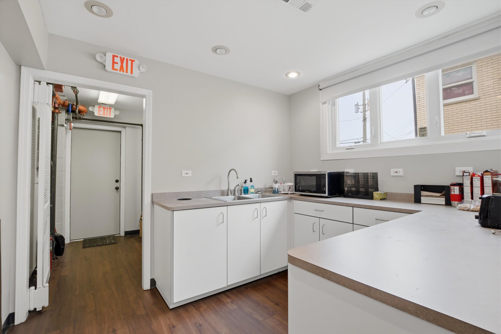 10550 West Cermak Road Westchester, IL 60154 - Photo 11 of 43 a kitchen with a sink cabinets and wooden floor