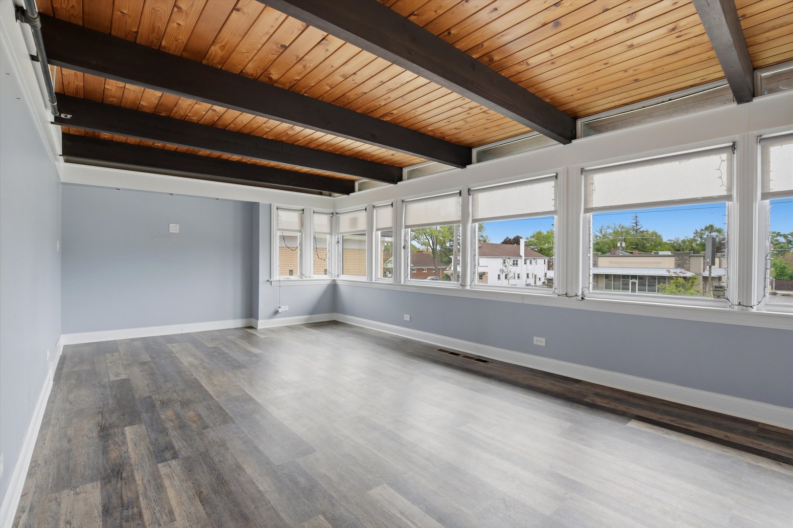 10550 West Cermak Road Westchester, IL 60154 - Photo 22 of 43 an empty room with wooden floor and windows