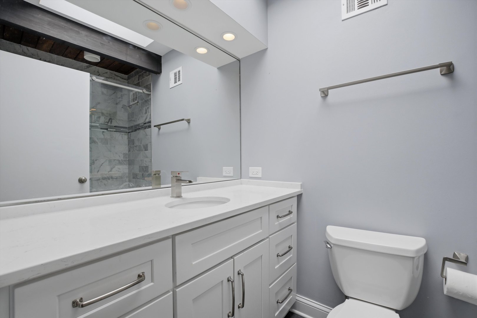 10550 West Cermak Road Westchester, IL 60154 - Photo 30 of 43 a bathroom with a granite countertop sink a toilet and a mirror