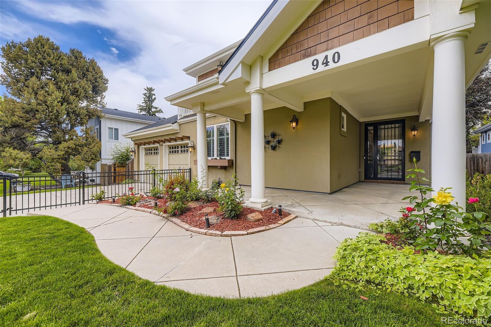 a view of a house with backyard and sitting area