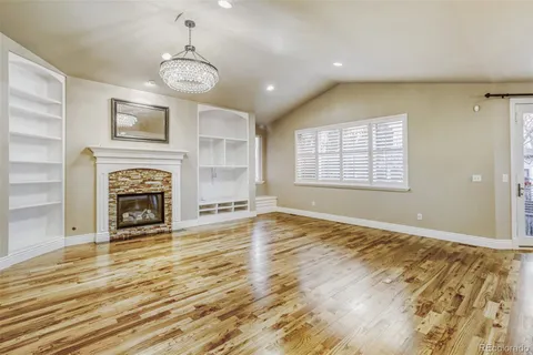 a view of an empty room with a fireplace and a window