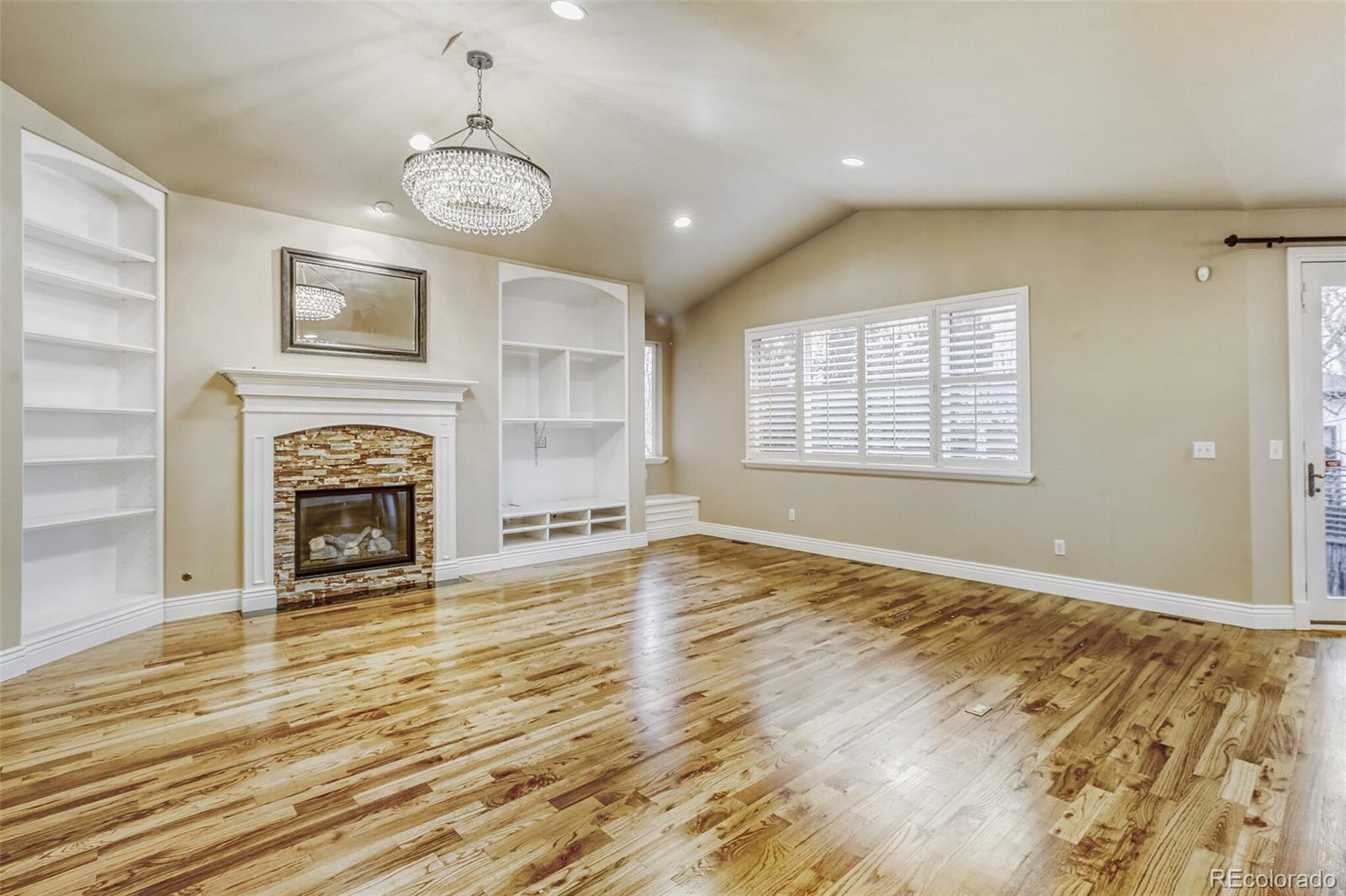 940 Kearney Street Denver, CO 80220 - Photo 11 of 49 a view of an empty room with a fireplace and a window