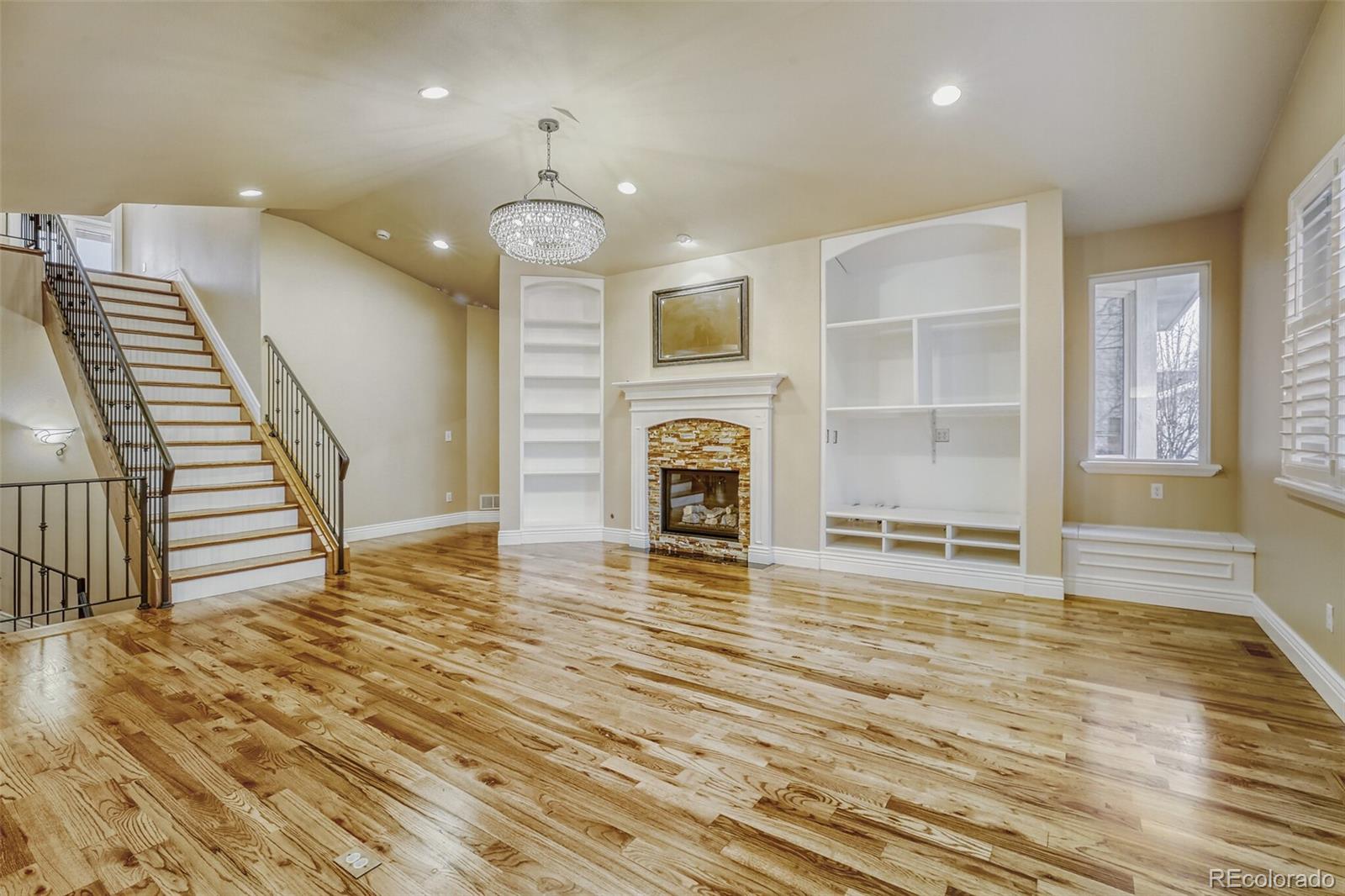 940 Kearney Street Denver, CO 80220 - Photo 12 of 49 an empty room with wooden floor and fireplace