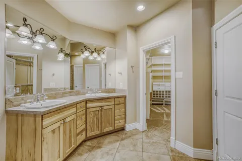 a spacious bathroom with a granite countertop sink a mirror and a