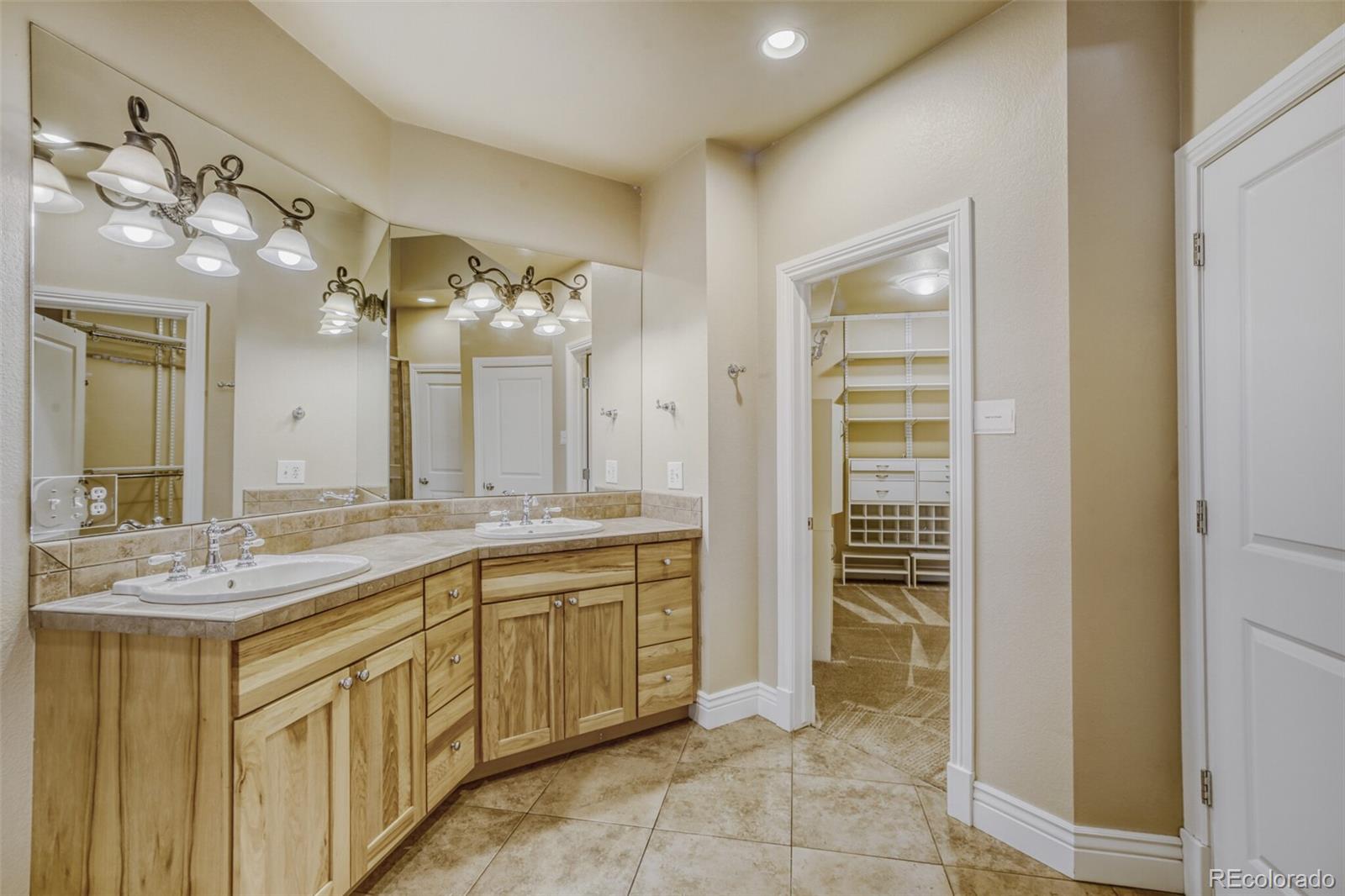940 Kearney Street Denver, CO 80220 - Photo 24 of 49 a spacious bathroom with a granite countertop sink a mirror and a