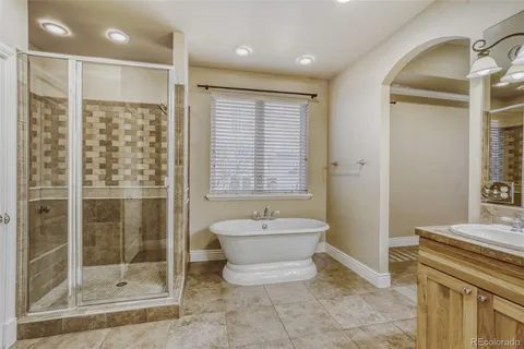 a spacious bathroom with a bathtub shower sink and toilet