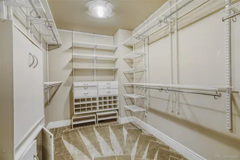 a view of walk in closet with empty racks