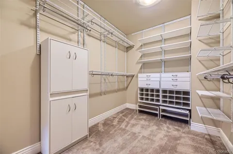 a view of walk in closet with empty racks