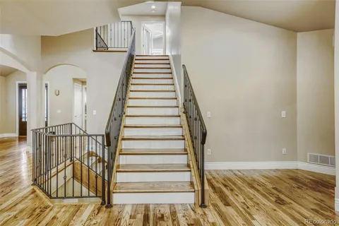 a view of entryway and hall with wooden floor