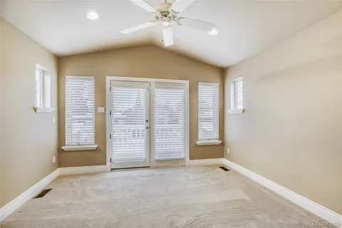 an empty room with windows and closet