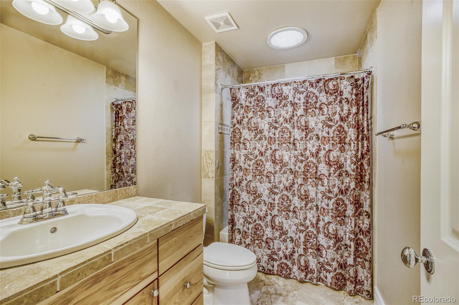 940 Kearney Street Denver, CO 80220 - Photo 33 of 49 a bathroom with a sink toilet and shower