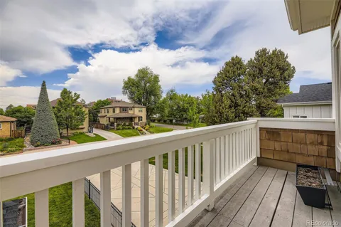 a view of a balcony with wooden fence