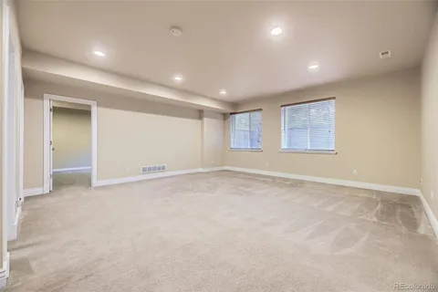an empty room with windows and closet