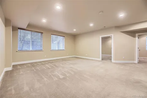 an empty room with windows and closet