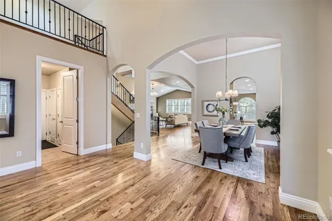 a view of a dining room and hall with wooden floor