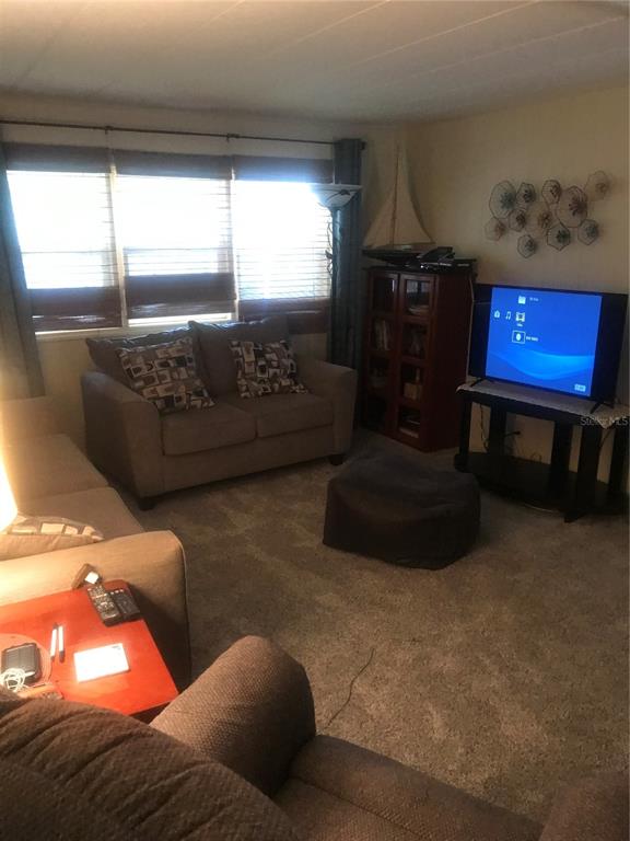 11076 100th Street, Unit 41 Largo, FL 33773 - Photo 13 of 17 a living room with furniture and a window