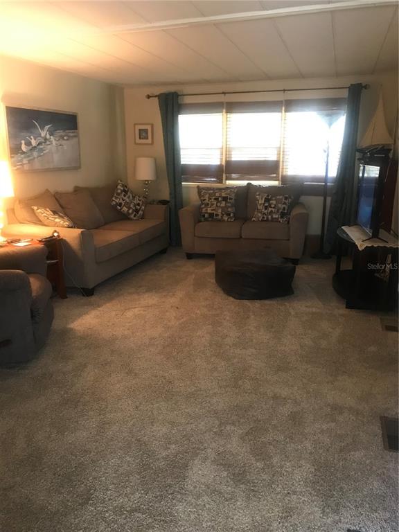 11076 100th Street, Unit 41 Largo, FL 33773 - Photo 14 of 17 a living room with furniture and a flat screen tv