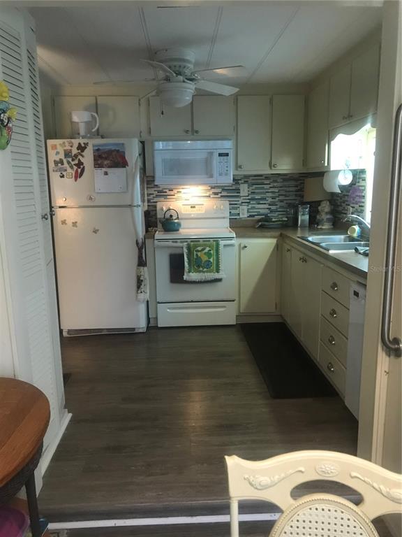 11076 100th Street, Unit 41 Largo, FL 33773 - Photo 15 of 17 a kitchen with a refrigerator and white cabinets