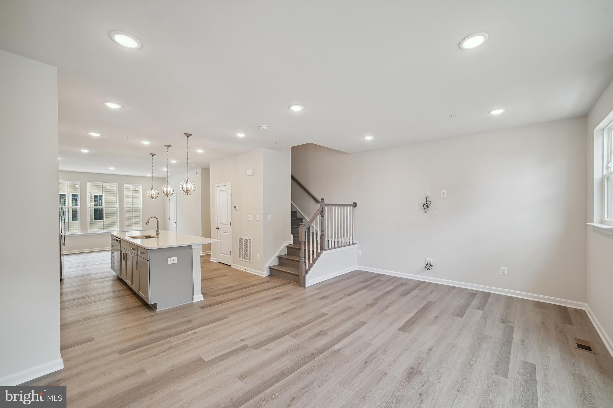 2513 Gatwick Lane Frederick, MD 21701 - Photo 4 of 14 a view of a living room and kitchen with wooden floor